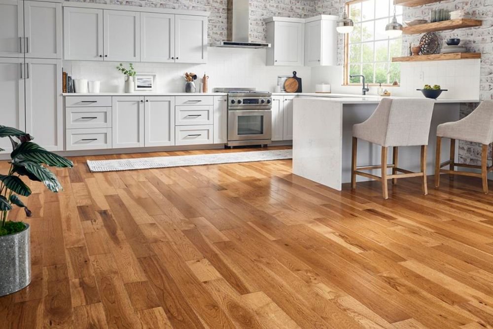 A well-lit kitchen with white walls and hardwood floors, emphasizing contemporary style in Seattle, WA.