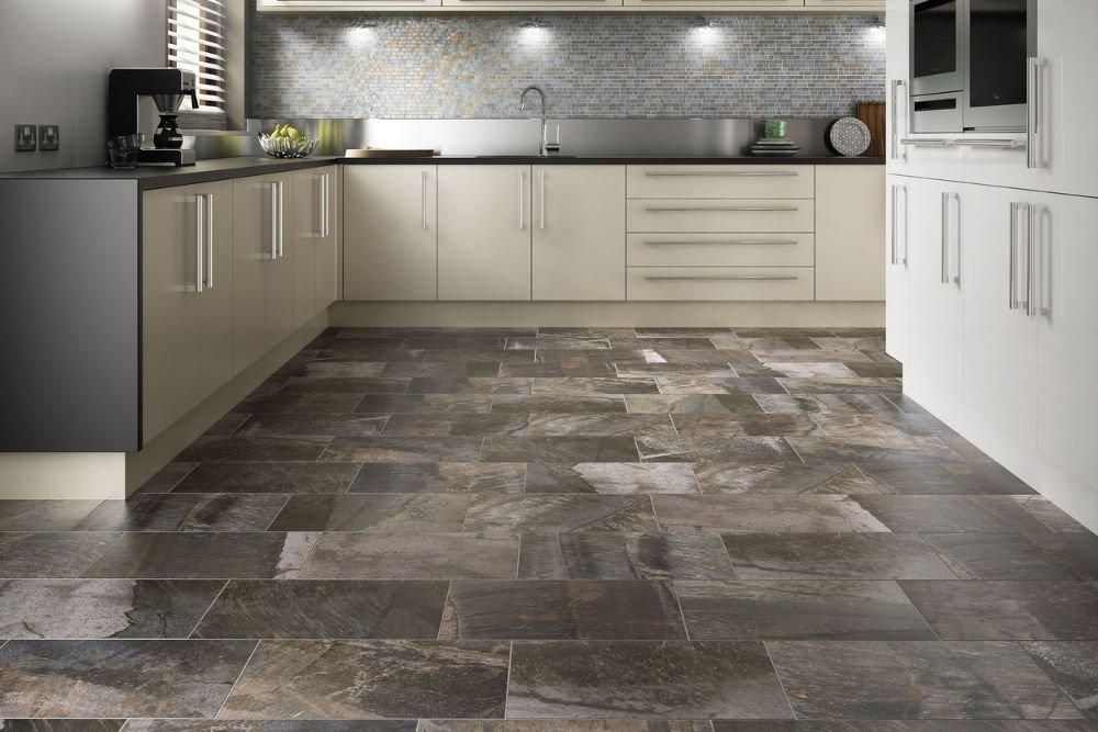 A contemporary kitchen with a tiled floor and expansive tile wall, representing tile flooring service in Seattle, WA.
