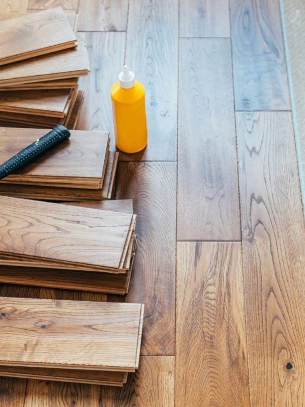 A wooden floor featuring an assortment of tools, indicative of a flooring service based in Seattle, WA.